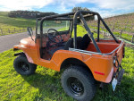 1972 Jeep CJ5 with new parts parked in a grassy area, showcasing its rugged design and off-road capabilities.
