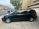 2009 Chrysler Town and Country Limited FWD, black minivan parked in residential area with new tires and power features.