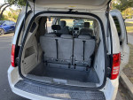 Interior view of a 2010 Chrysler Town & Country with rear seats folded for extra cargo space.
