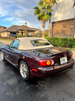 2000 Mazda Miata Special Edition with a soft top parked in a sunny location, showcasing its sleek design.