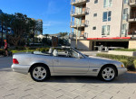 2000 Mercedes-Benz SL500 convertible with low mileage parked outdoors, showcasing original paint and new soft top.