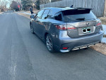 2015 Lexus CT 200h in gray parked on a residential street, showcasing luxury and sporty design