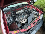 Engine compartment view of a 1997 Toyota Tercel showing components and details.
