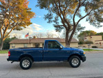 2008 Ford Ranger in excellent condition, blue color, parked in front of a house with trees, showcasing its 76,000 miles.