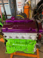 2000 Honda Prelude engine with purple VTEC cover and green block, showcasing performance upgrades and new components.
