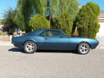 1968 Chevrolet Camaro in blue with a new paint job, showcasing its straight body and new tires.