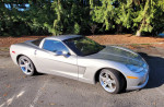 2005 Chevrolet Corvette C6 in silver metallic with low miles, parked among trees
