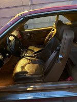 Interior view of a 1997 Mercedes-Benz SL500 with leather seats and dashboard details.