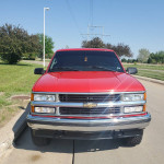 Front view of a 1999 Chevrolet Tahoe SUV in excellent condition, parked on a sunny day