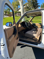 Interior view of a well-maintained 1996 Ford Ranger with manual transmission and power features.