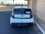 Rear view of a 2018 Kia Soul hatchback in white color parked in a lot, showcasing clean design and features.