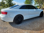 2013 Audi A5 Quattro in white with custom wheels and tinted windows, showcasing its stylish design and features.