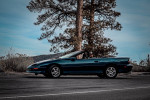 1997 Chevrolet Camaro Z28 convertible parked in scenic landscape with trees