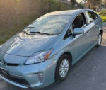 2014 Toyota Prius Plug-in hybrid in Seagreen color, showcasing excellent condition and features.