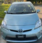 Front view of a 2014 Toyota Prius Plug-in in Seagreen color with 119,000 miles
