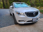 2016 Buick Enclave in excellent condition with white frost exterior and Choccochino interior parked on gravel driveway