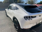 White Ford Mustang Mach-E Premium electric SUV with black rims parked outdoors
