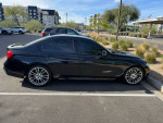 Side view of a black 2013 BMW 335i with M-Sport package parked, showcasing stylish design and premium features.