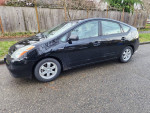 2009 Toyota Prius parked on the street, demonstrating its sleek design and spacious interior.