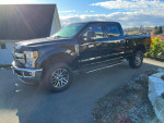 2018 Ford F350 XLT FX4 truck with rebuilt status, shown outdoors on a sunny day.