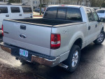 2008 Ford F150 XLT 4X4 silver pickup truck with clean exterior and good tires, showing rear view and bed.