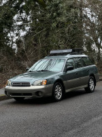 2001 Subaru Outback AWD wagon parked in excellent condition with new battery, sunroof, and clean interior