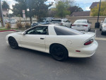 1997 Chevrolet Camaro Z28 RWD in pristine condition with 20k miles and supercharger, parked in a lot.