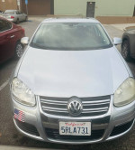 Front view of a 2024 Volkswagen Jetta with leather seats and sunroof, in excellent condition.