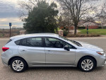 2019 Subaru Impreza in silver with low mileage, parked in a residential area.