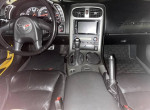 Interior view of a 2005 Chevrolet Corvette showcasing dashboard, steering wheel, and upgraded audio system.