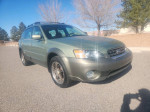 2005 Subaru Outback with 142,000 miles, equipped with all wheel drive and sunroof, parked in a clear area.