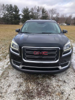 Front view of a clean 2014 GMC Acadia with all-wheel drive parked in an open field.