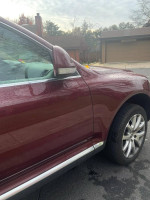 2008 Burgundy Volkswagen Touareg showcasing sleek design and features like adjustable suspension and premium sound system.