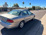 1999 Oldsmobile Intrigue GL in good condition parked on the street, showcasing its sleek design and exterior.