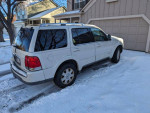 2004 Lincoln Aviator Luxury SUV parked in snow, showcasing its white exterior and spacious design.