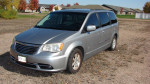 2013 Chrysler Town & Country Touring in silver, showcasing its stylish design and spacious interior.