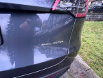Close-up of a Tesla Model Y rear with 'Dual Motor' badge displayed on the trunk