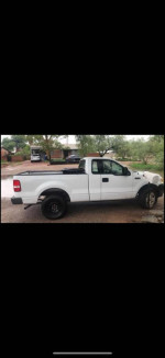 2006 Ford F150 XL pickup truck with low mileage and new tires, parked in a residential area.