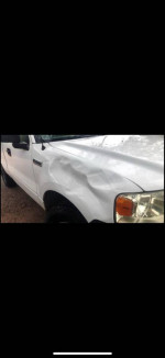 2006 Ford F150 with minor dents on the front hood, low mileage, well-maintained, ready for daily driving.