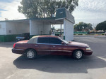Side view of a Lincoln Towncar, well-maintained, suitable for daily drivers and commuters.