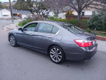 Side view of a 2014 Honda Accord EX FWD parked on a street, showcasing sleek design and alloy wheels.