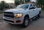 2021 Ram 2500 Tradesman 4WD truck in white with chrome accents parked in a residential area.