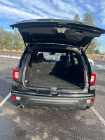 Open trunk of a 2019 Honda Passport Sport showing spacious interior and clean detailing.