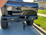 Rear view of a lifted 2007 Chevrolet Silverado with aftermarket upgrades and thick tires