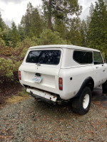 1972 International Scout in need of repair, showcasing solid floors and broken left front axle, parked outdoors.