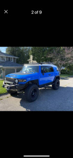 2007 Toyota FJ Cruiser in blue with custom features and off-road tires