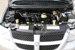 Dodge Grand Caravan engine view with components including battery and coolant reservoir, showcasing low mileage and mobility features.