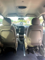 Interior view of a Dodge Caravan with lowered floor and removable front seats, designed for wheelchair accessibility.