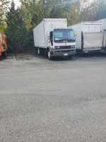 2000 GMC T7500 truck with power tailgate and low mileage parked in a lot