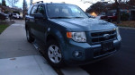 2012 Ford Escape Hybrid FWD parked on the street, showcasing a clean exterior and all-wheel drive features.